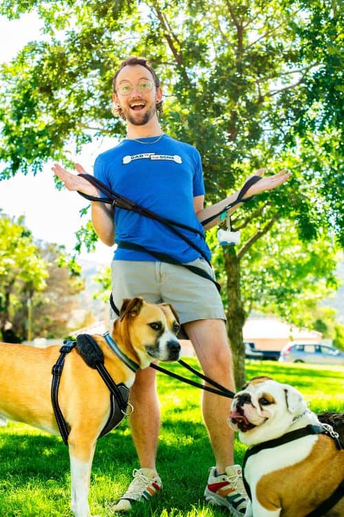 doug the dog guys posting with 2 dogs twisted in a leash doug keeling